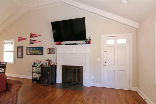 a living room with a fireplace and a flat screen tv