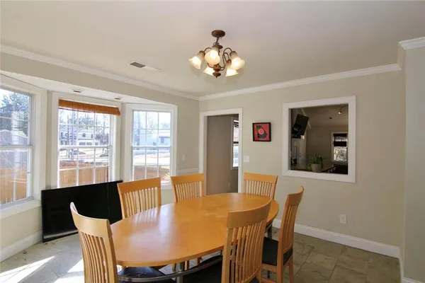 a view of a dining room with furniture window and outside view