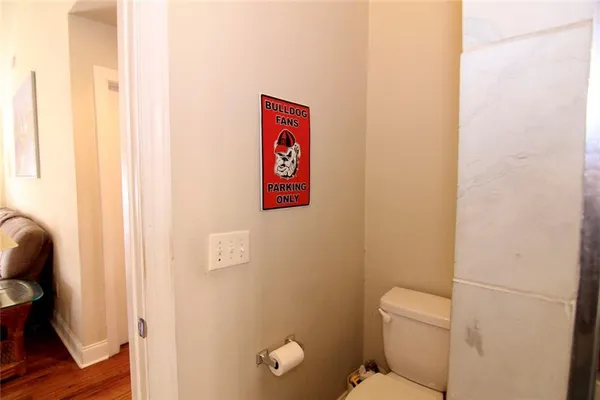 a bathroom with a toilet and a shower curtain