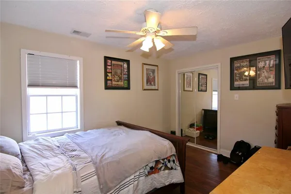 a bedroom with a bed and a window