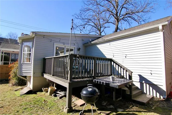 a view of backyard with deck and chairs