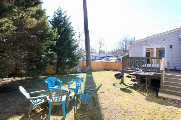 a view of a patio with a dining table and chairs with wooden floor