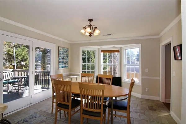 a view of a dining room with furniture window and outside view