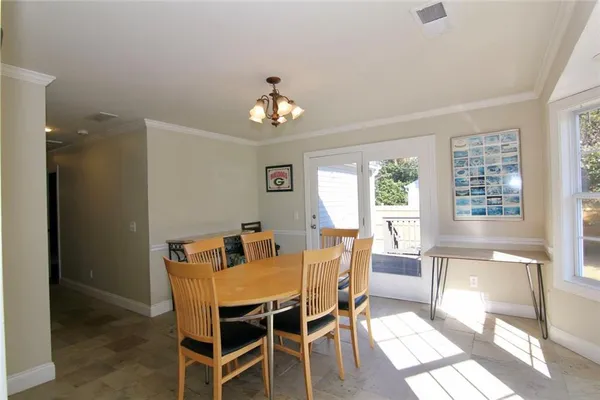 a view of a dining room with furniture wooden floor and a chandelier