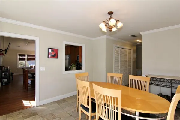 a dining room with furniture and chandelier