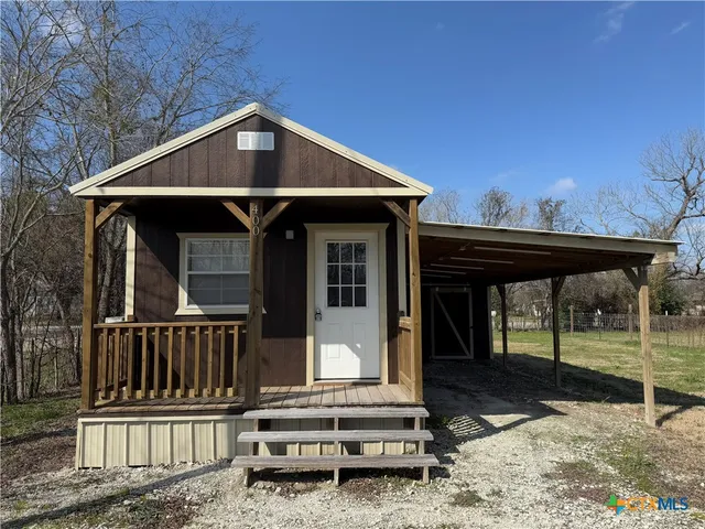 a front view of a house with wooden fence