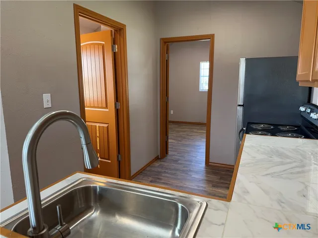 a view of an entryway with wooden floor