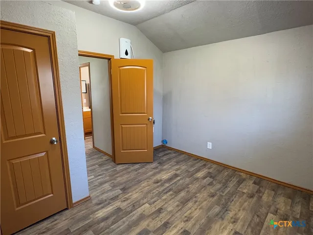 a view of a refrigerator in kitchen and wooden floor