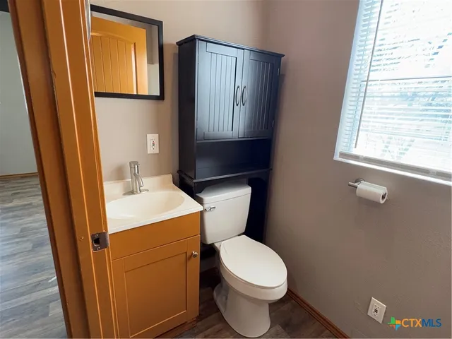 a bathroom with a toilet sink and mirror