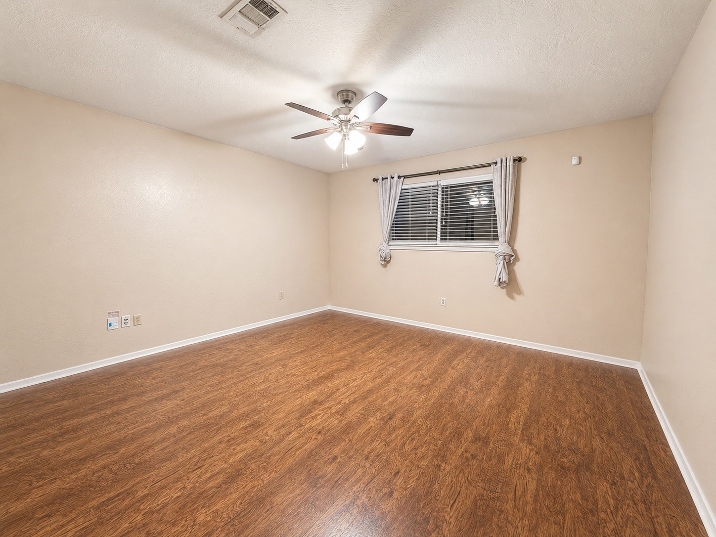 5810 Sunnygate Drive Spring, TX 77373 - Photo 6 of 16 wooden floor in an empty room with a window