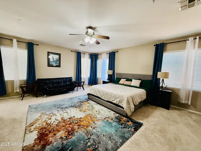 a bedroom with a large bed and a window