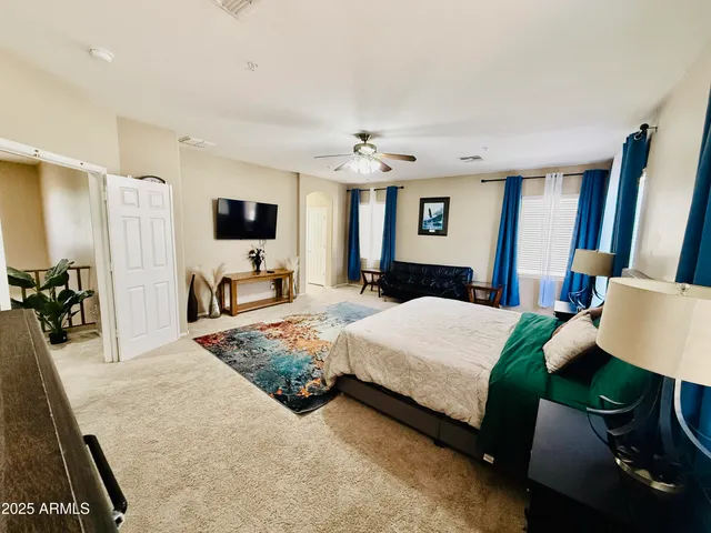 a bedroom with a bed and a couch