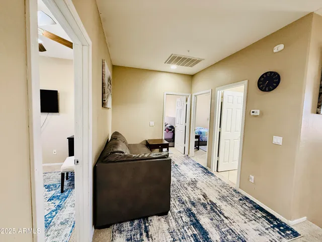 a patio with a table and chairs and potted plants
