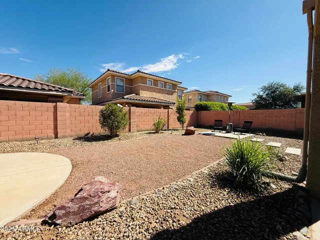 an aerial view of a house with garden space and lake view
