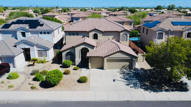 an aerial view of residential houses with outdoor space and swimming pool