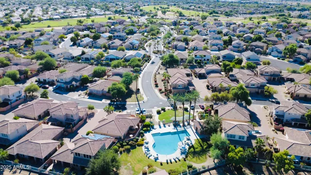 a view of a swimming pool with lawn chairs under an umbrella