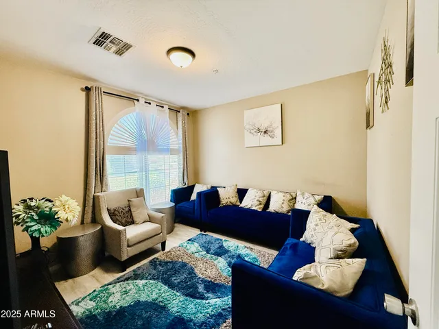 a living room with furniture and a large window