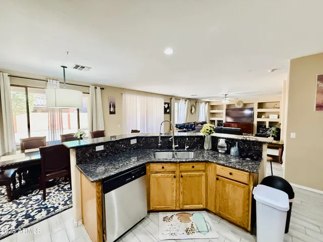 a kitchen with stainless steel appliances granite countertop a sink and cabinets
