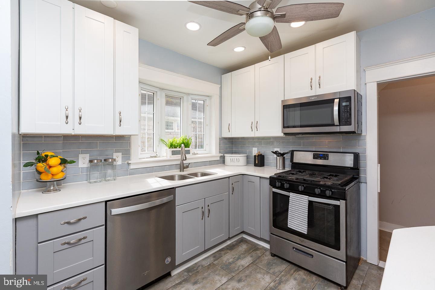 2029 Laurel Road Havertown, PA 19083 - Photo 16 of 45 a kitchen with stainless steel appliances granite countertop a stove a sink a microwave a refrigerator and cabinets