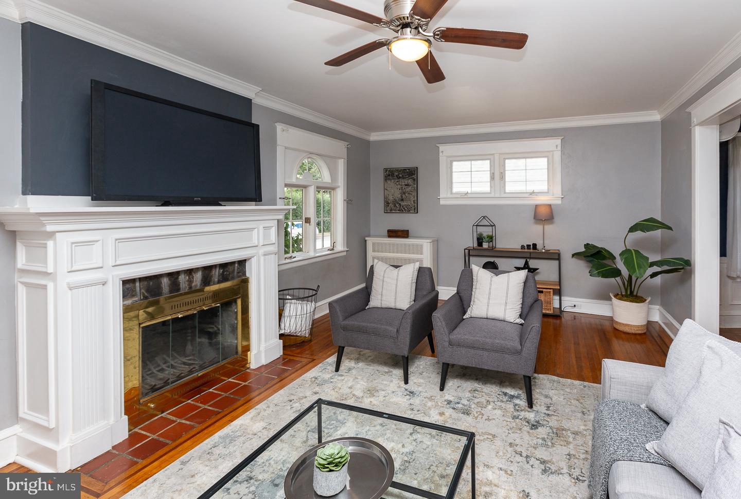 2029 Laurel Road Havertown, PA 19083 - Photo 7 of 45 a living room with furniture a flat screen tv and a fireplace