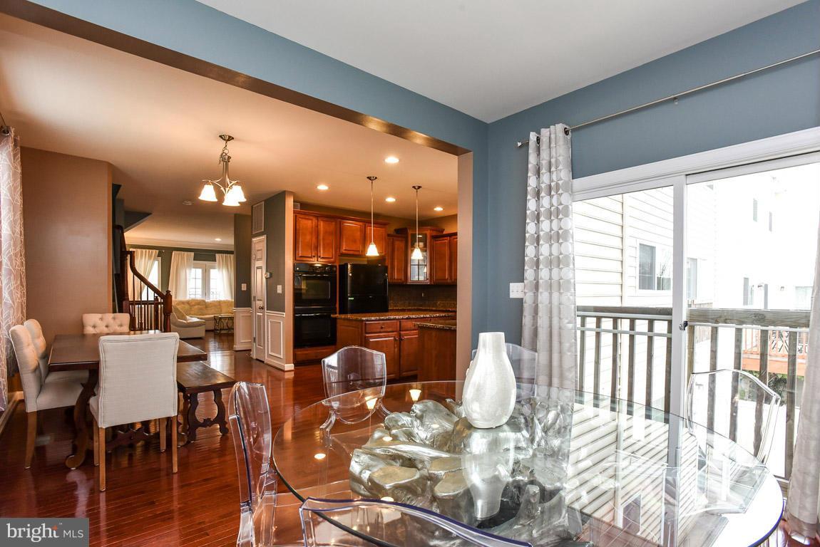 25175 Prairie Fire Square Aldie, VA 20105 - Photo 11 of 28 a view of a dining room with furniture wooden floor and chandelier