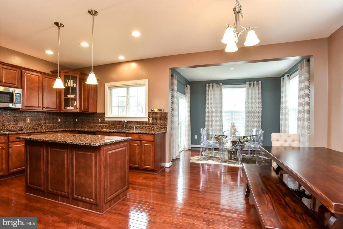 25175 Prairie Fire Square Aldie, VA 20105 - Photo 12 of 28 a large kitchen with kitchen island a large island in it
