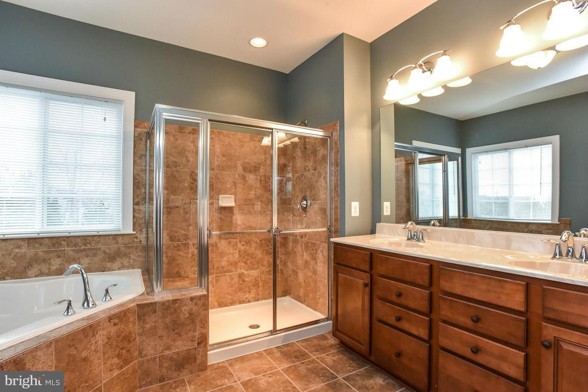 25175 Prairie Fire Square Aldie, VA 20105 - Photo 16 of 28 a spacious bathroom with a tub sink shower and mirror
