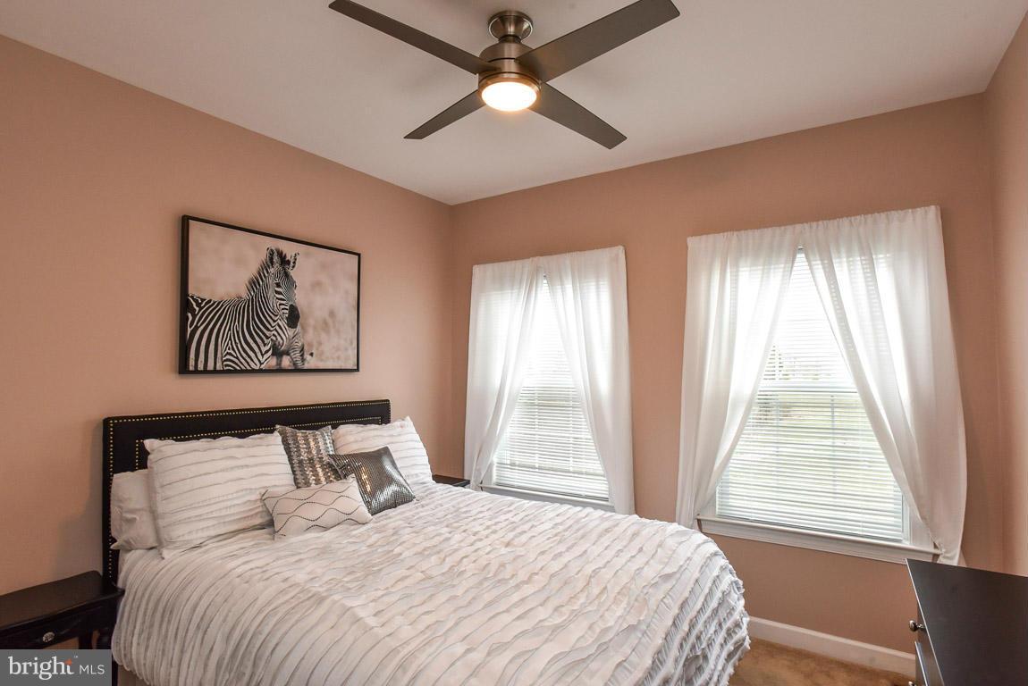 25175 Prairie Fire Square Aldie, VA 20105 - Photo 18 of 28 a bedroom with a large bed and a window