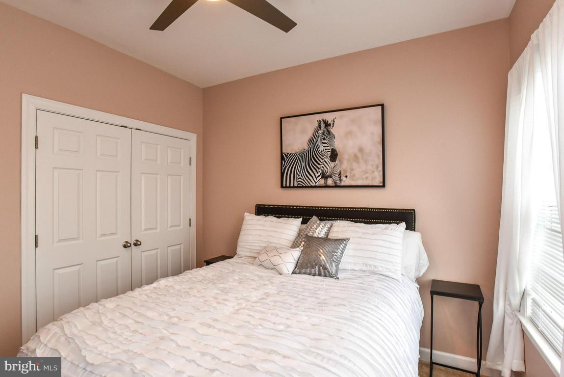 25175 Prairie Fire Square Aldie, VA 20105 - Photo 19 of 28 a bedroom with a bed and a painting on the wall