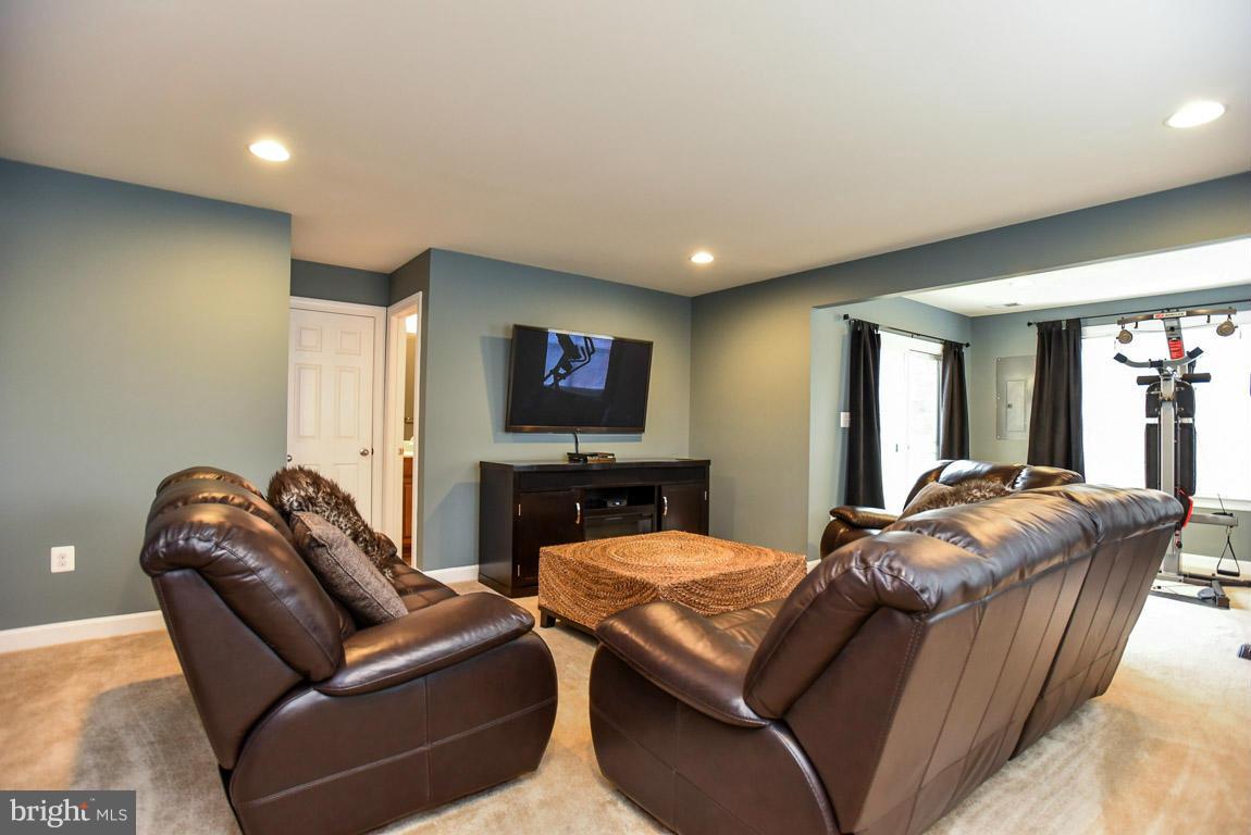 25175 Prairie Fire Square Aldie, VA 20105 - Photo 24 of 28 a living room with furniture and a flat screen tv