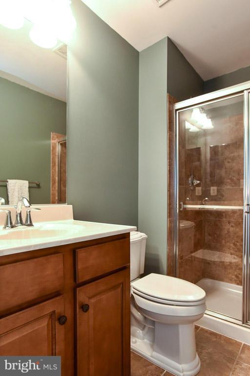 25175 Prairie Fire Square Aldie, VA 20105 - Photo 27 of 28 a bathroom with a sink a toilet a mirror and shower