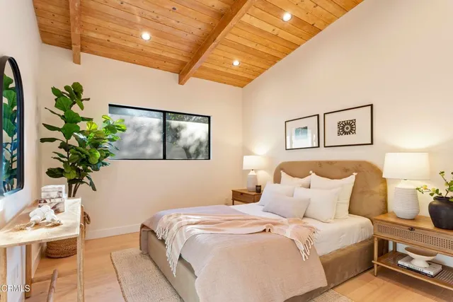 a bedroom with a bed and a potted plant