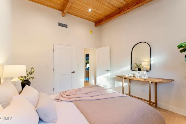 a bedroom with a bed and a table