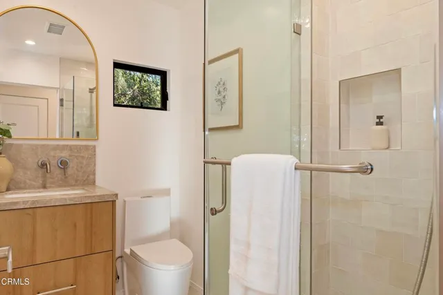 a bathroom with a toilet sink and shower