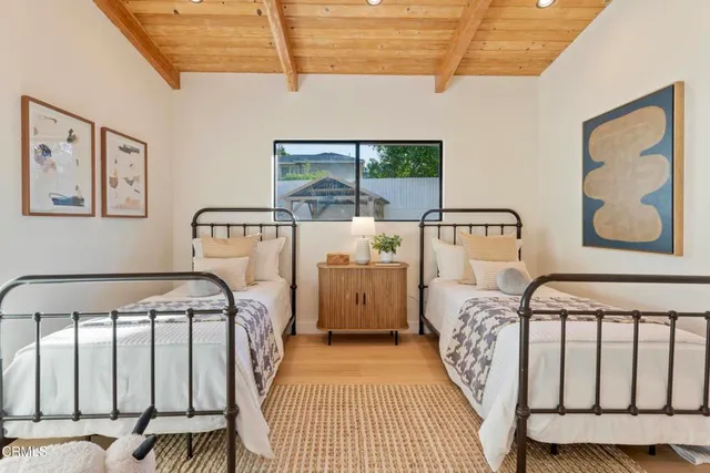 a view of a bedroom with furniture and window