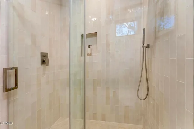 a bathroom with a glass shower door
