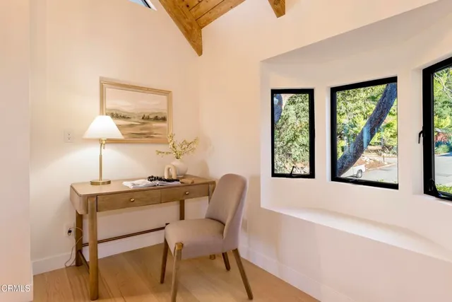 a dining room with furniture and a window