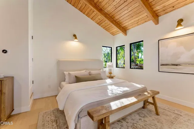 a bedroom with a bed and a painting on the wall