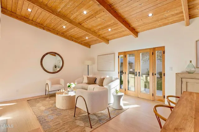 a living room with furniture a fireplace and a table