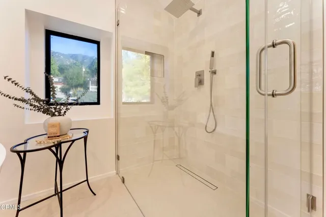 a bathroom with a glass shower door
