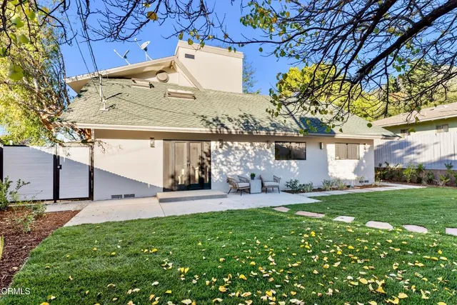 a view of a house with a yard and sitting area