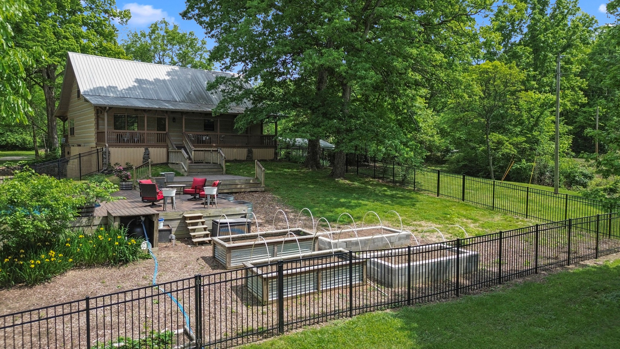 1708 Sugar Ridge Road Spring Hill, TN 37174 - Photo 50 of 59 a view of a patio with table and chairs potted plants and large tree