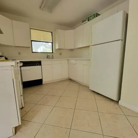 a bathroom with a granite countertop shower and a toilet