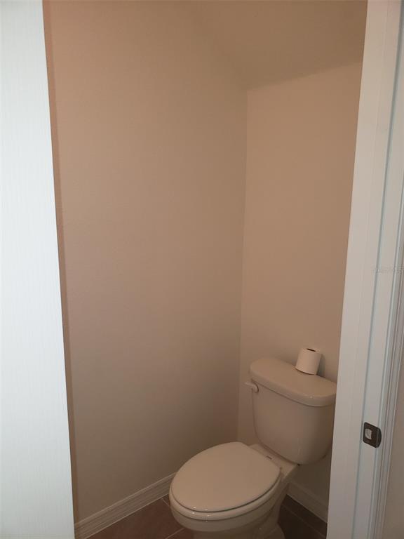 1670 Rock Elm Road Davenport, FL 33837 - Photo 11 of 28 a white toilet sitting next to a shower