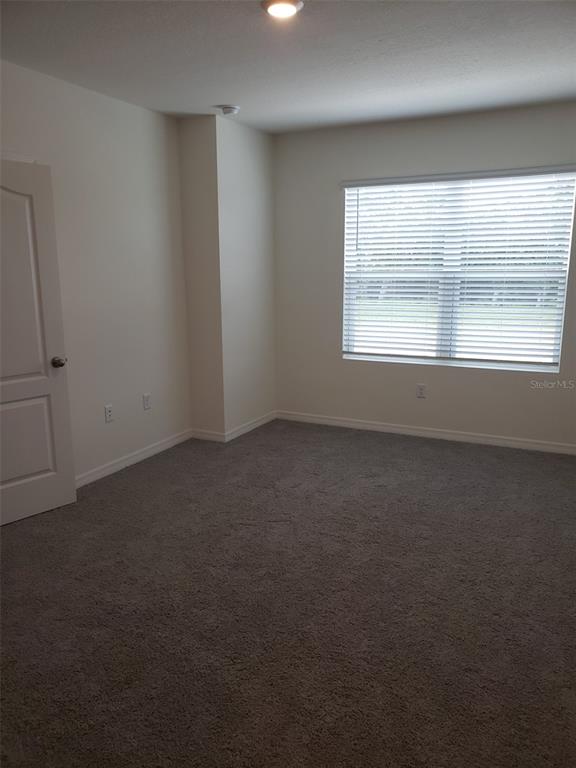 1670 Rock Elm Road Davenport, FL 33837 - Photo 13 of 28 an empty room with a window