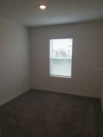 an empty room with closet area