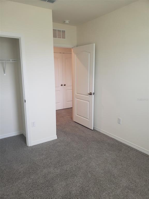 1670 Rock Elm Road Davenport, FL 33837 - Photo 19 of 28 an empty room with closet area