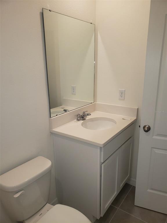 1670 Rock Elm Road Davenport, FL 33837 - Photo 21 of 28 a bathroom with a sink and a toilet