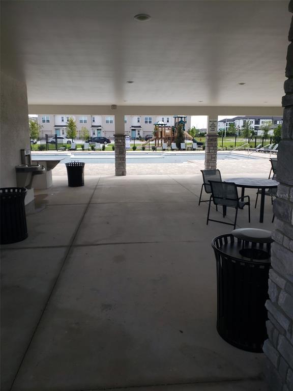 1670 Rock Elm Road Davenport, FL 33837 - Photo 26 of 28 a living room with chairs and a stove