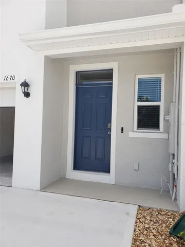 a view of a hallway with wooden floor and a bathroom